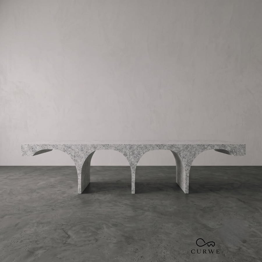 Setu granite coffee table on a row of arched legs