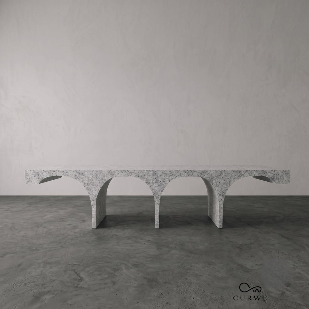 Setu granite coffee table on a row of arched legs