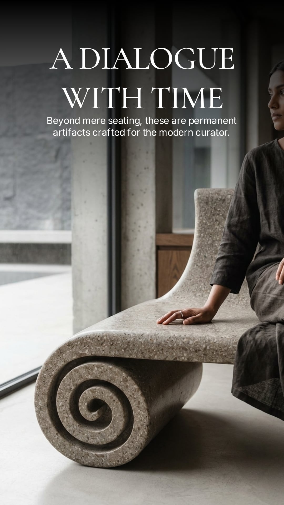 Guest resting a hand on a coiled bench beside floor-to-ceiling windows