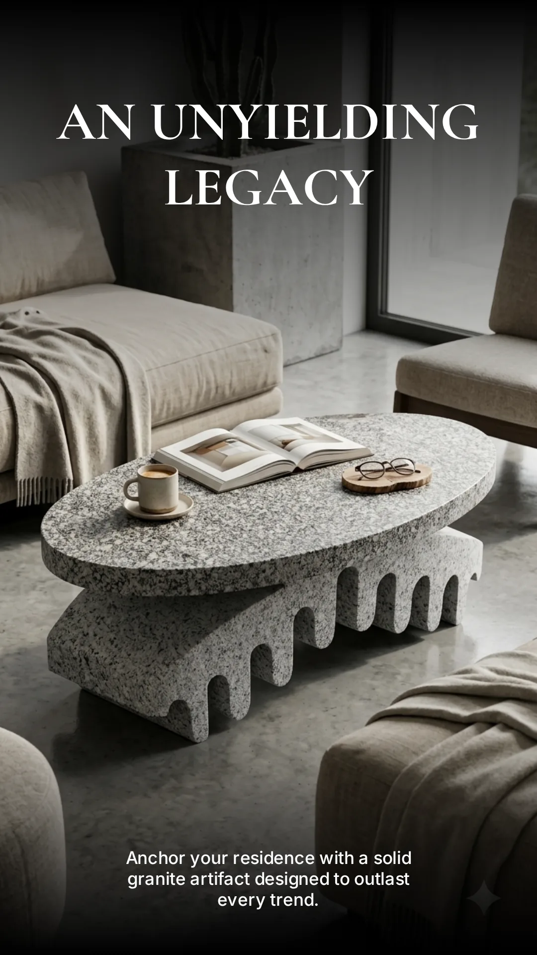 Oval granite coffee table with a dripping base, styled with a book and coffee